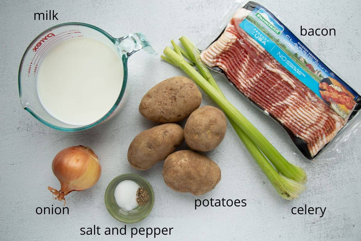 potatoes, bacon, milk, and other ingredients on a white table.