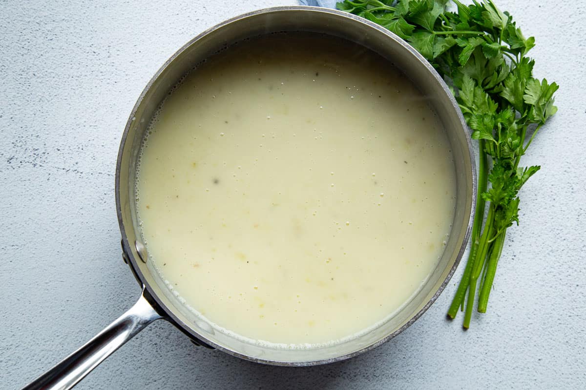 creamy potato soup in a saucepan.
