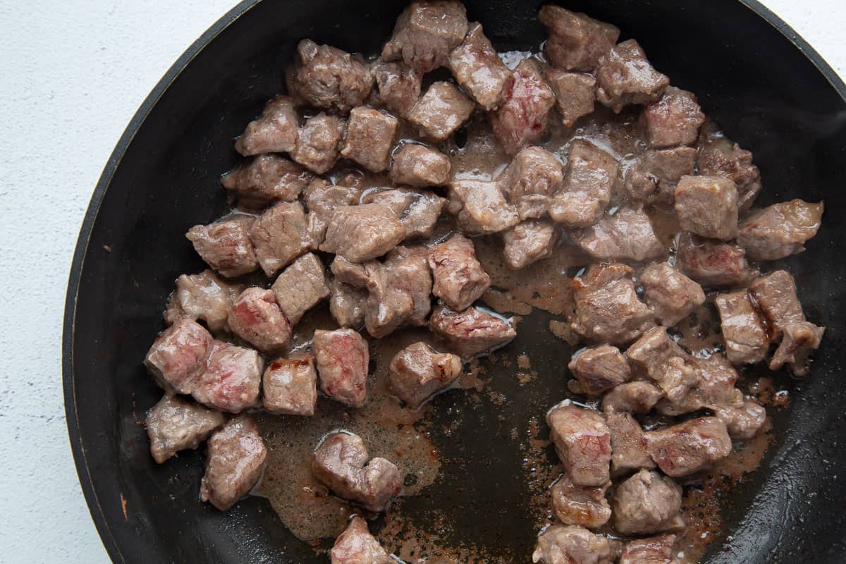 sirloin steak cubes in a large skillet.