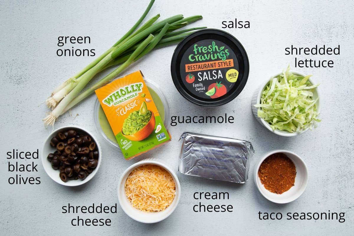 ingredients for 7 layer taco dip on a white table.