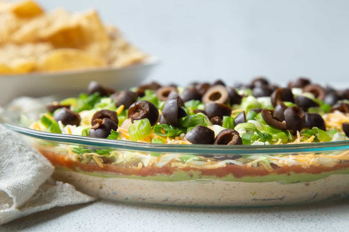 7 layer taco dip in a glass pie dish.