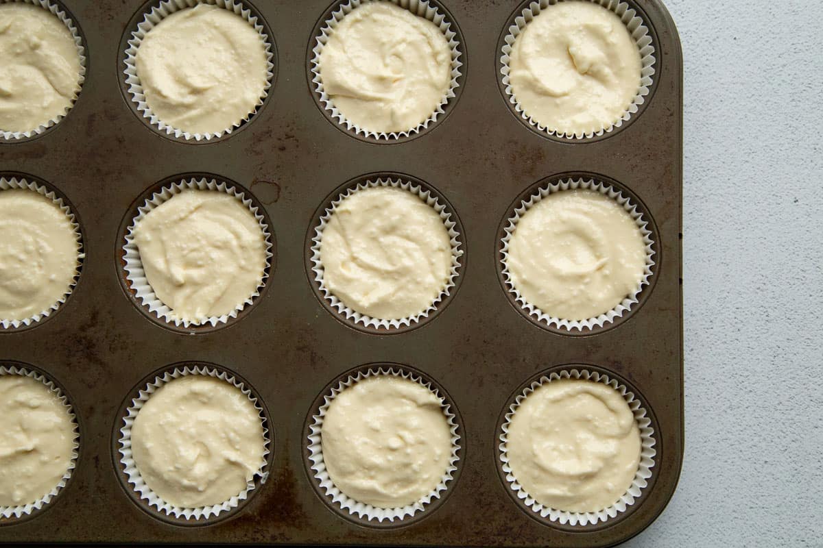 cream cheese mixture in cupcake liners in a 12-cup muffin tin.