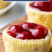 mini cherry cheesecakes on a wooden board.