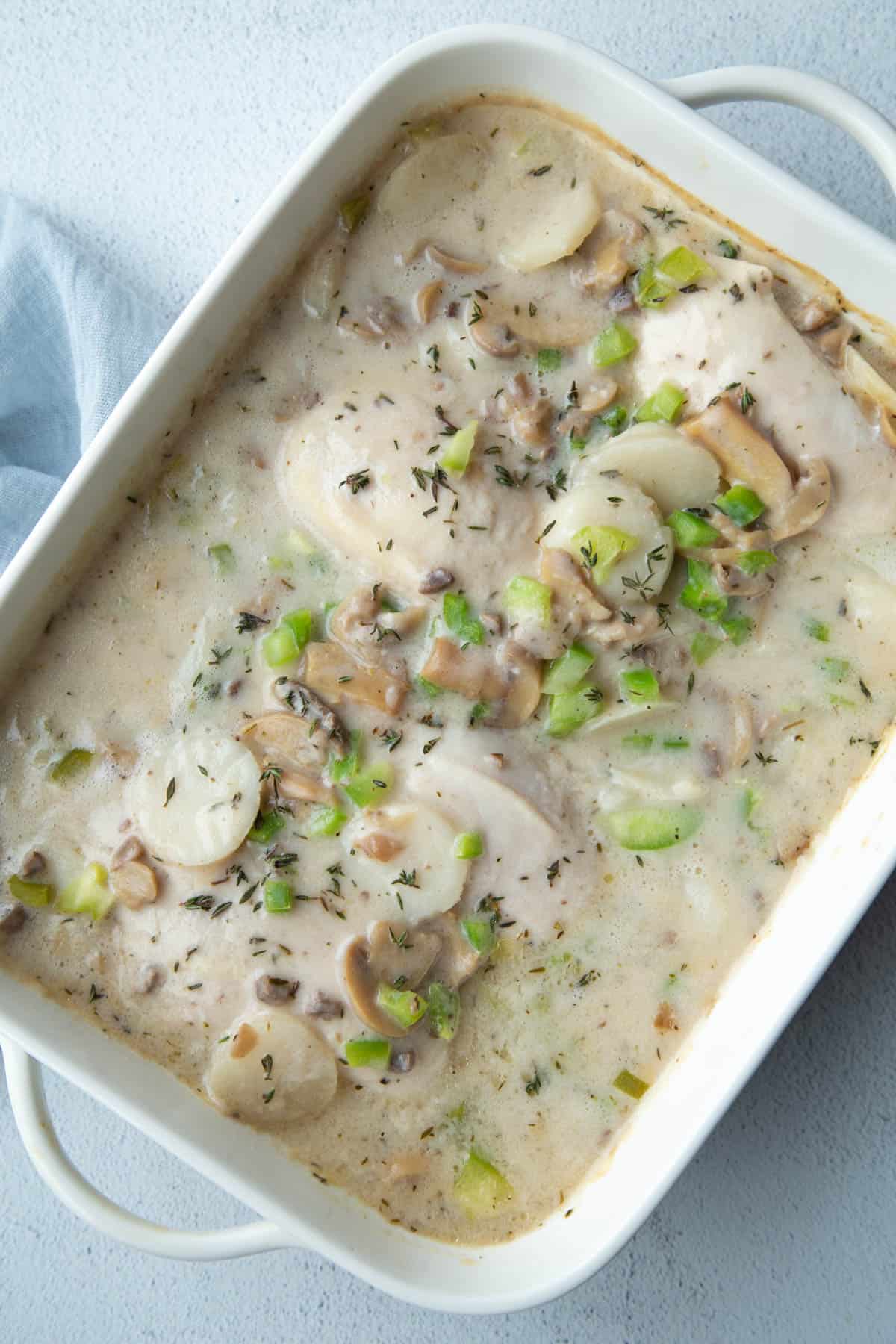 cream of mushroom chicken in a white casserole dish.
