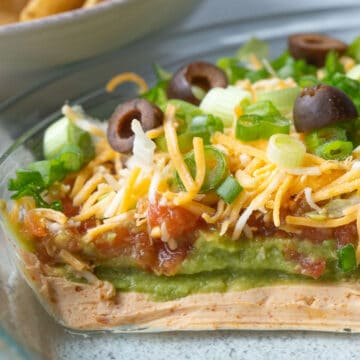 7 layer taco dip in a glass pie dish.