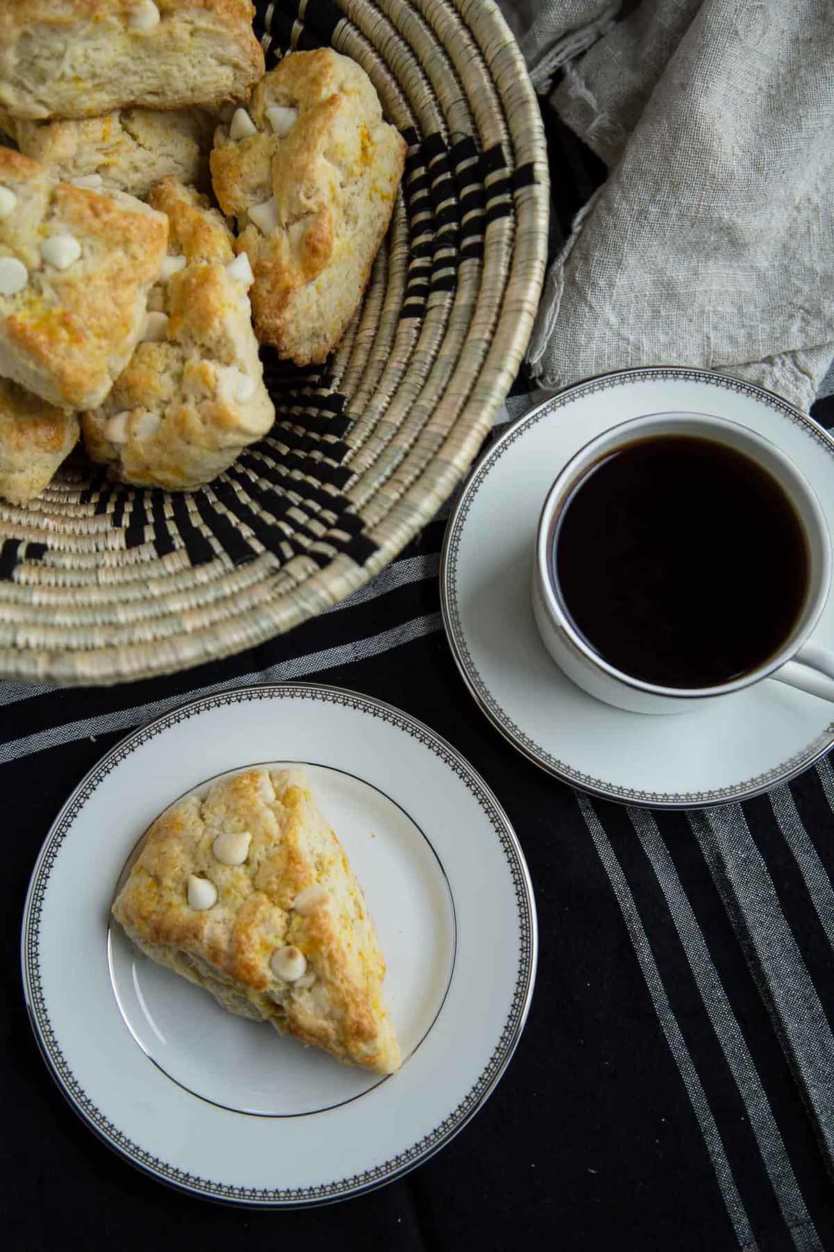 orange scones and a cup of coffee on a table.