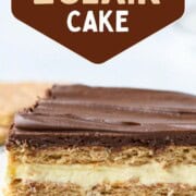slice of eclair cake with layers of vanilla pudding and graham crackers, topped with a chocolate frosting.