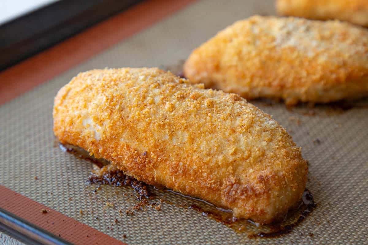 baked parmesan chicken breasts on a sheet pan.