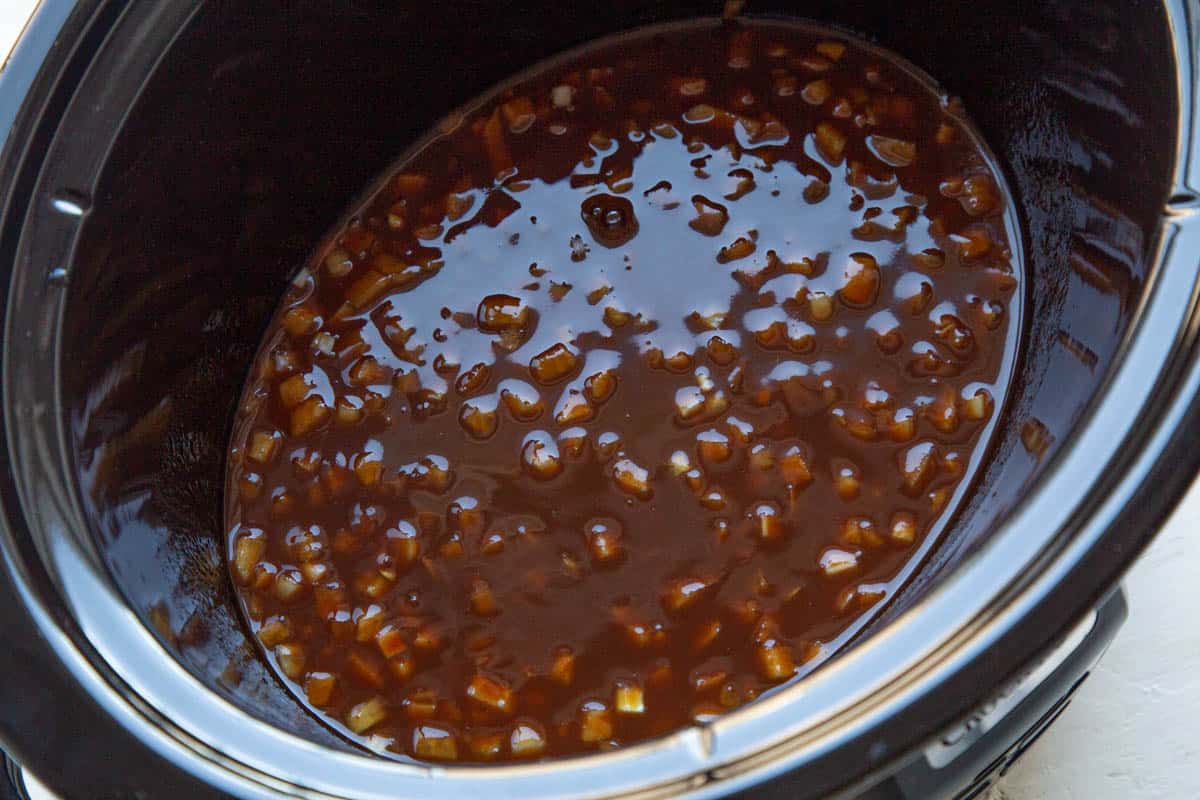 bbq sauce and diced onion in a slow cooker.