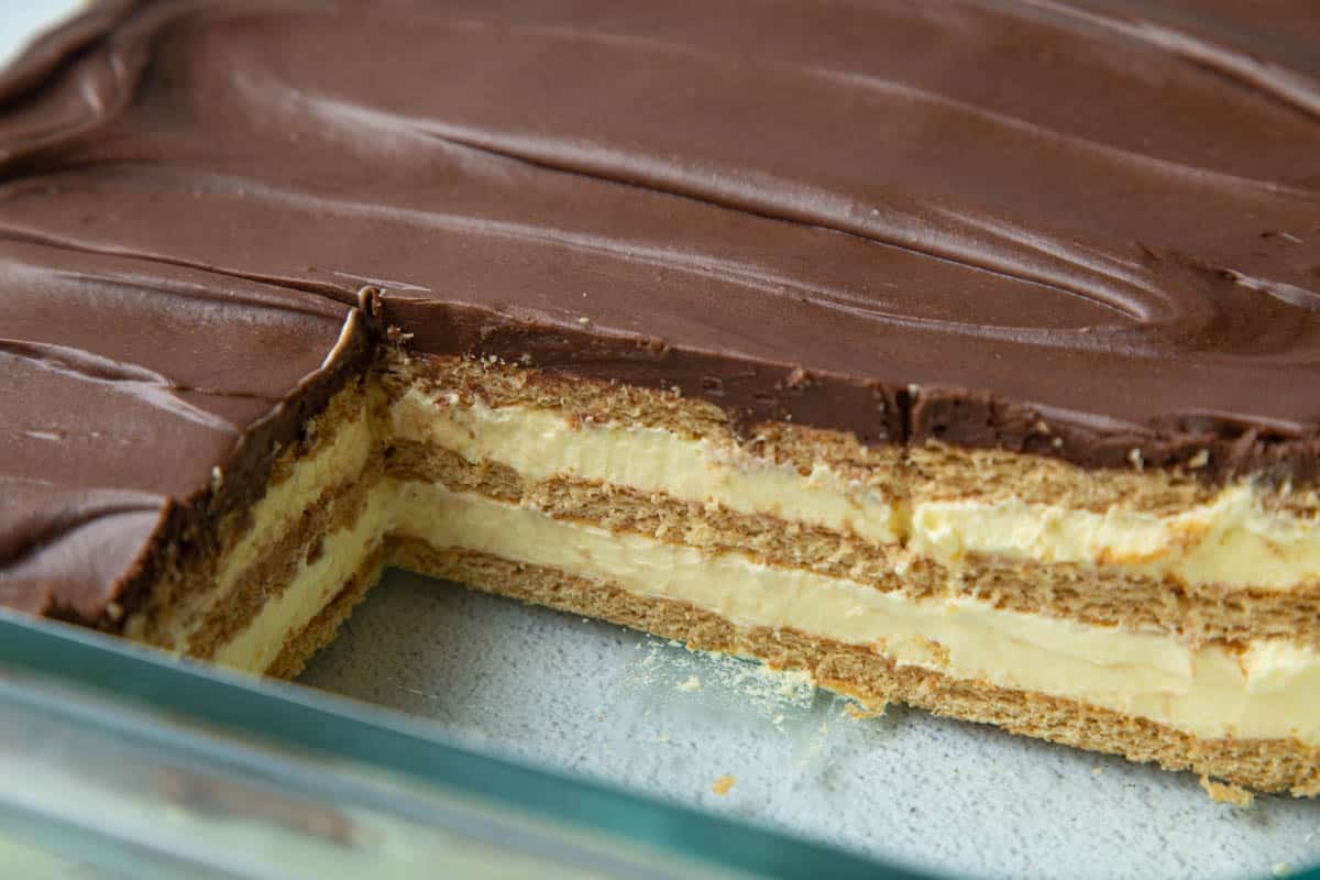 cross section of chocolate eclair cake in a glass casserole dish.