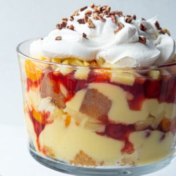 trifle dish filled with layers of cake, pudding, pie filling, and whipped cream.