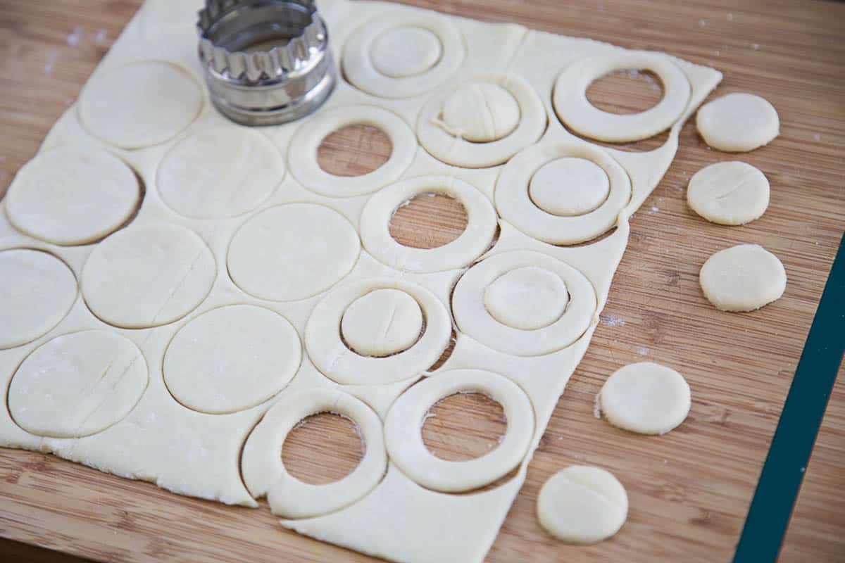 sheet of puff pastry with circles cut out of it.
