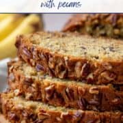 three slices of banana bread stacked on top of each other on a wooden serving board.