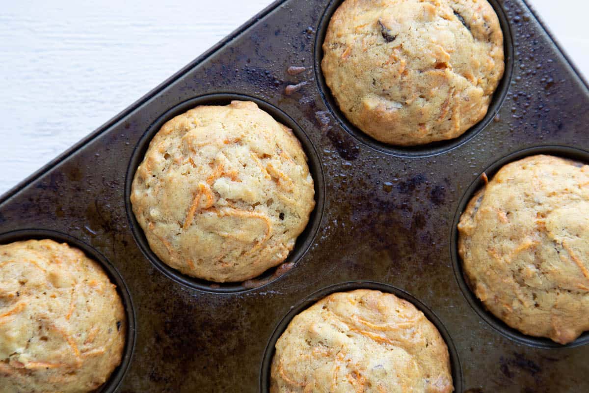 carrot muffins in a metal muffin tin.