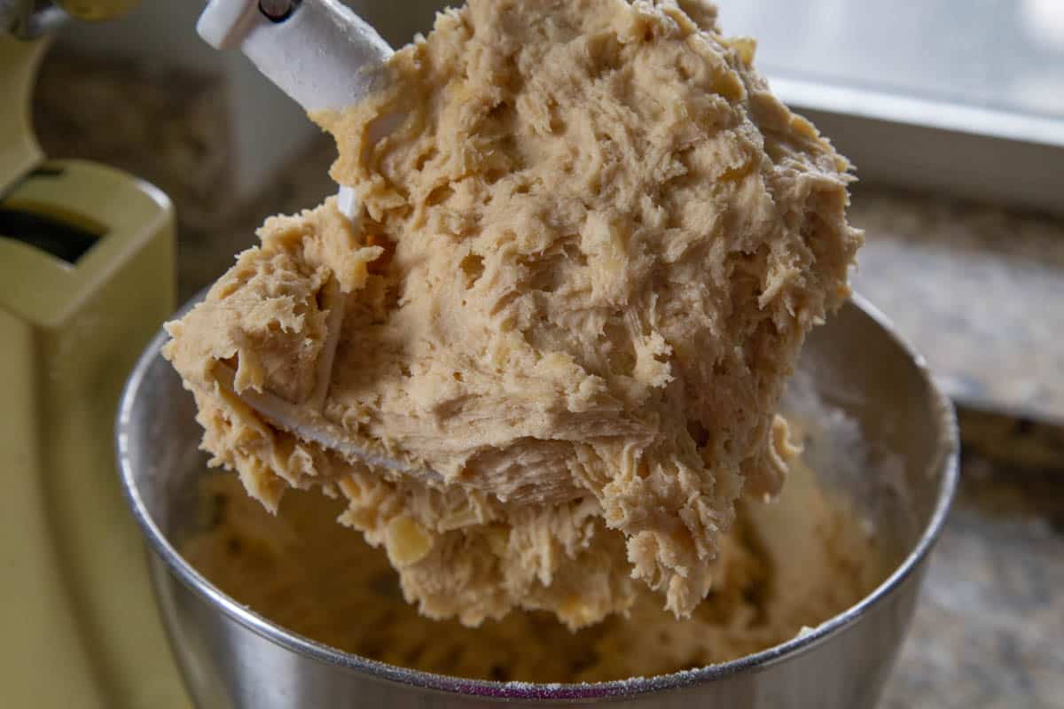 pineapple cookie dough in a stand mixer with a paddle attachment.