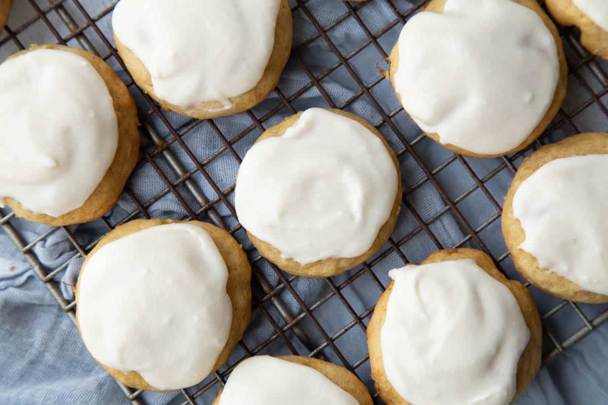 pineapple cookies with frosting on a wire rack.