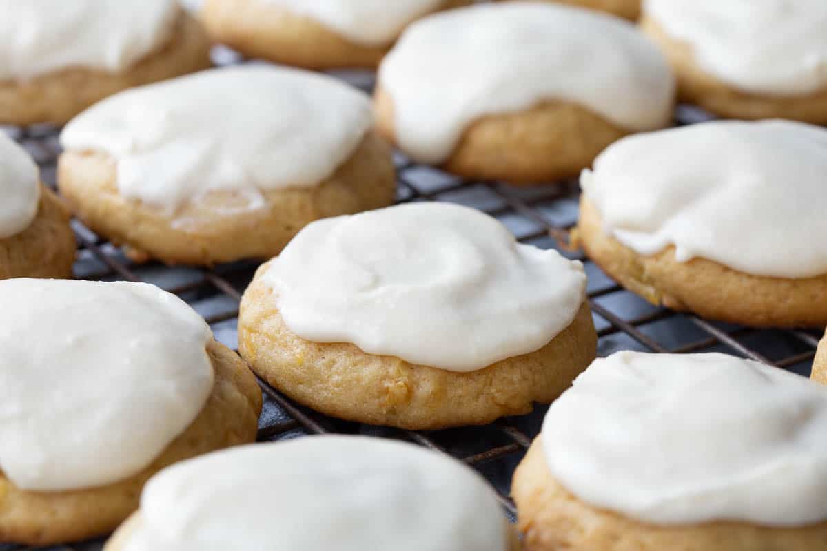 frosted pineapple cookies on a wire rack.