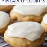 soft pineapple cookies on a wire rack, topped with vanilla frosting.