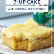 slice of 7up cake topped with coconut pineapple frosting next to a can of 7up.