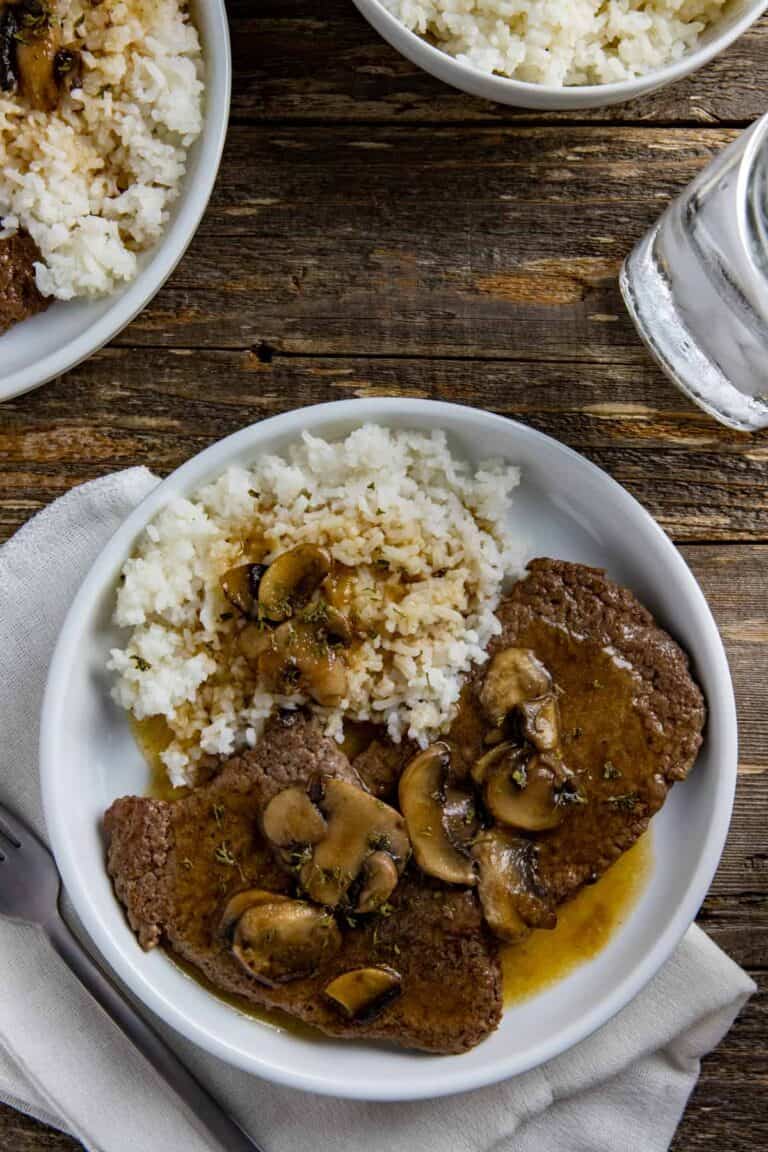 cube steak topped with mushrooms and brown gravy.