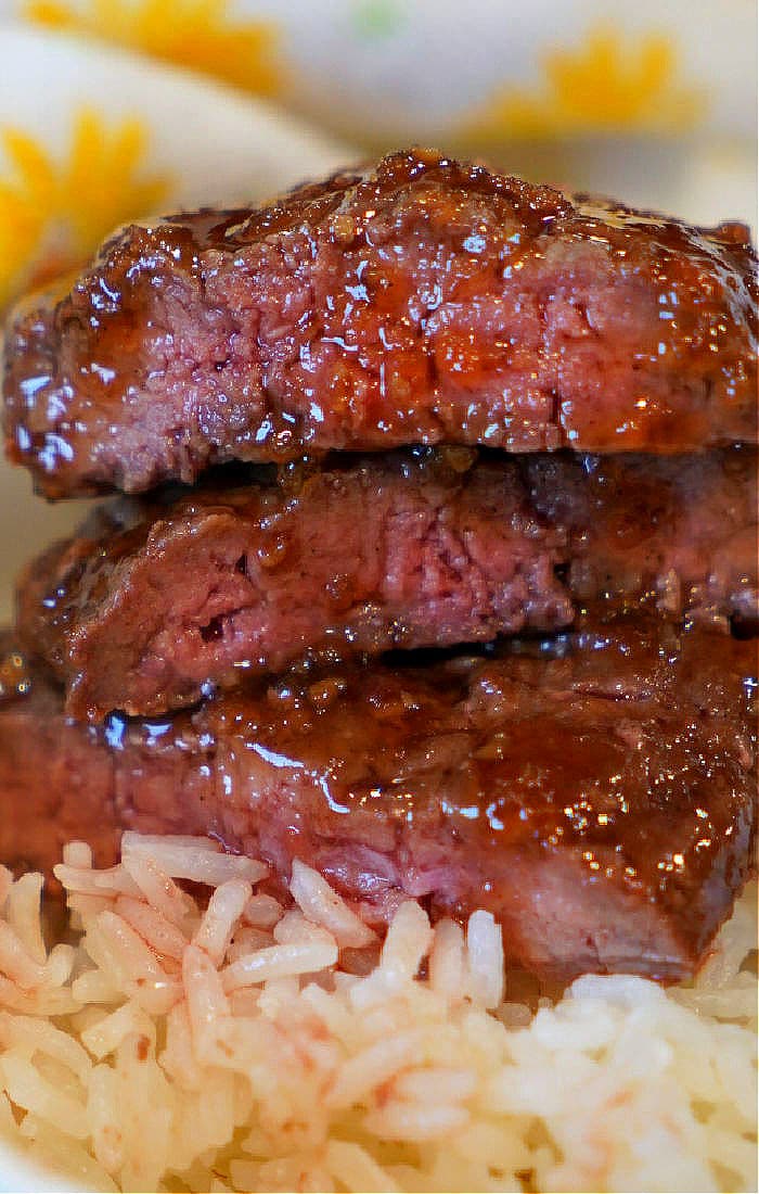 cube steak coated in teriyaki glaze with rice.