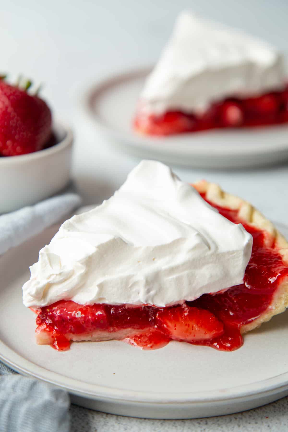 slice of strawberry pie with jello on a white plate.