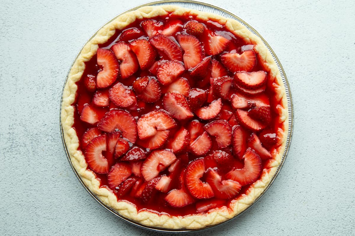 sliced strawberries and red gelatin in a pie shell.