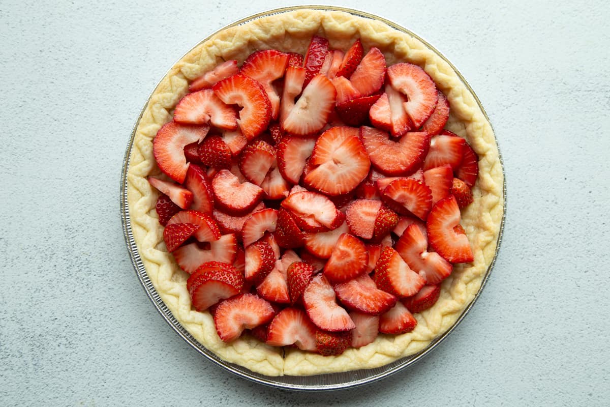 sliced strawberries in a pie shell.