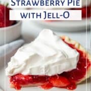 slice of strawberry pie topped with whipped topping on a white plate.