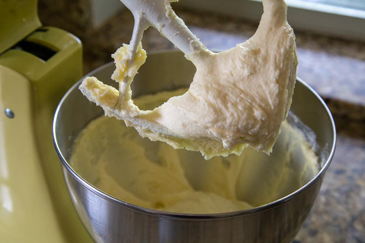 stand mixer with a paddle attachment with a creamy butter and sugar mixture.