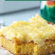 slice of yellow cake with yellow pineapple frosting on top.