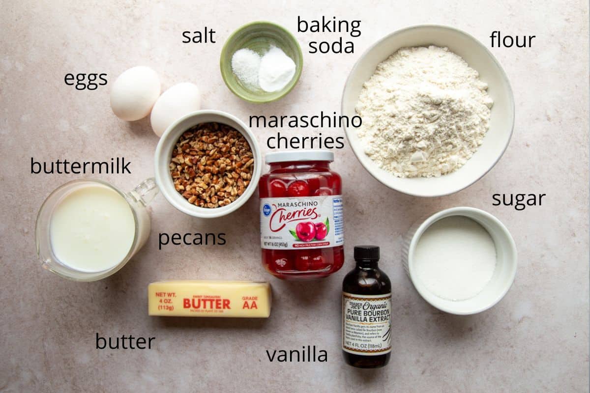 flour, butter, sugar, and other ingredients on a soft pink background.