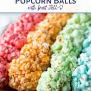 rows of colorful marshmallow popcorn balls on a metal sheet pan.