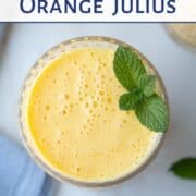 top down view of an orange julius in a glass, garnished with fresh mint.