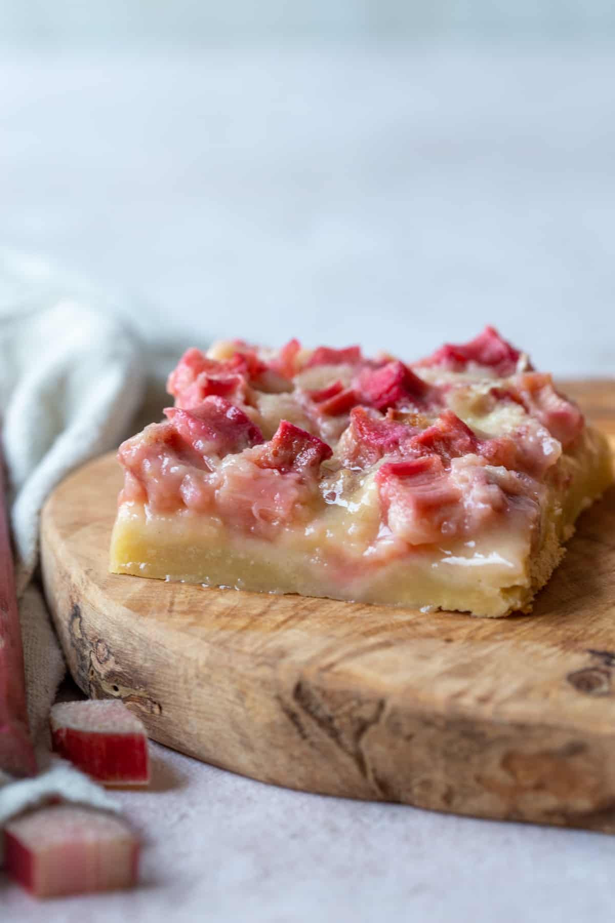 old fashioned rhubarb bar on a decorative wooden board. 