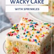 slice of vanilla wacky cake with sprinkles inside, frosting on top, and more sprinkles on top on a white plate.
