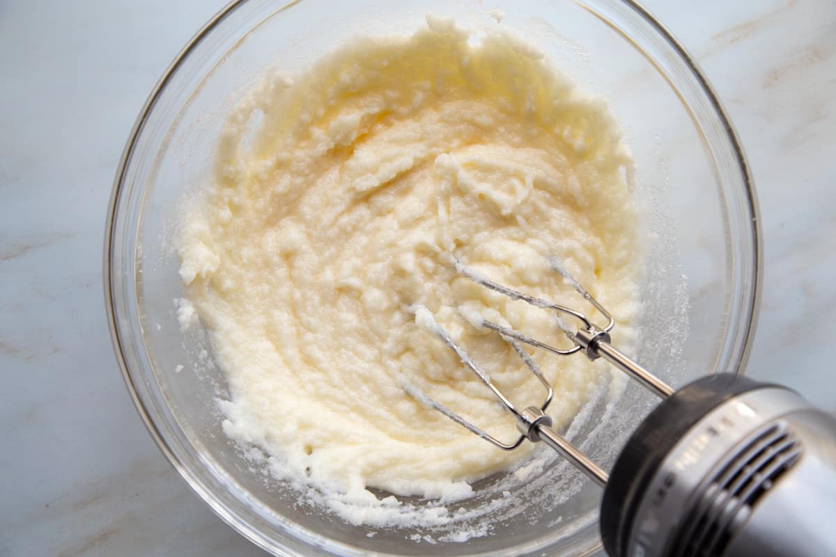 butter and sugar creamed together in a glass bowl.