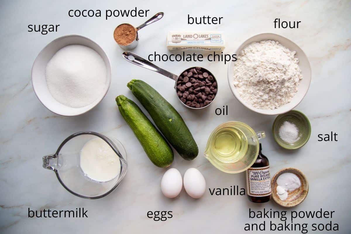 sugar, flour, eggs, and other baking ingredients on a white table.