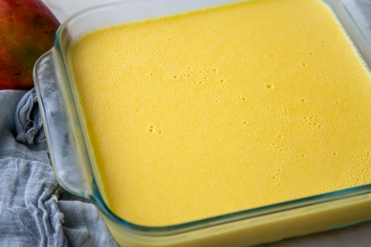 mango gelatin in a square glass casserole dish. 