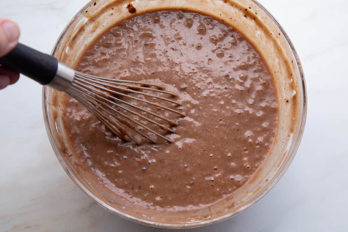 hand whisking chocolate cake batter.