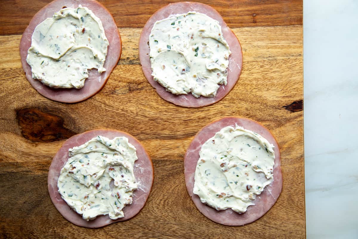 cream cheese spread onto slices of ham.