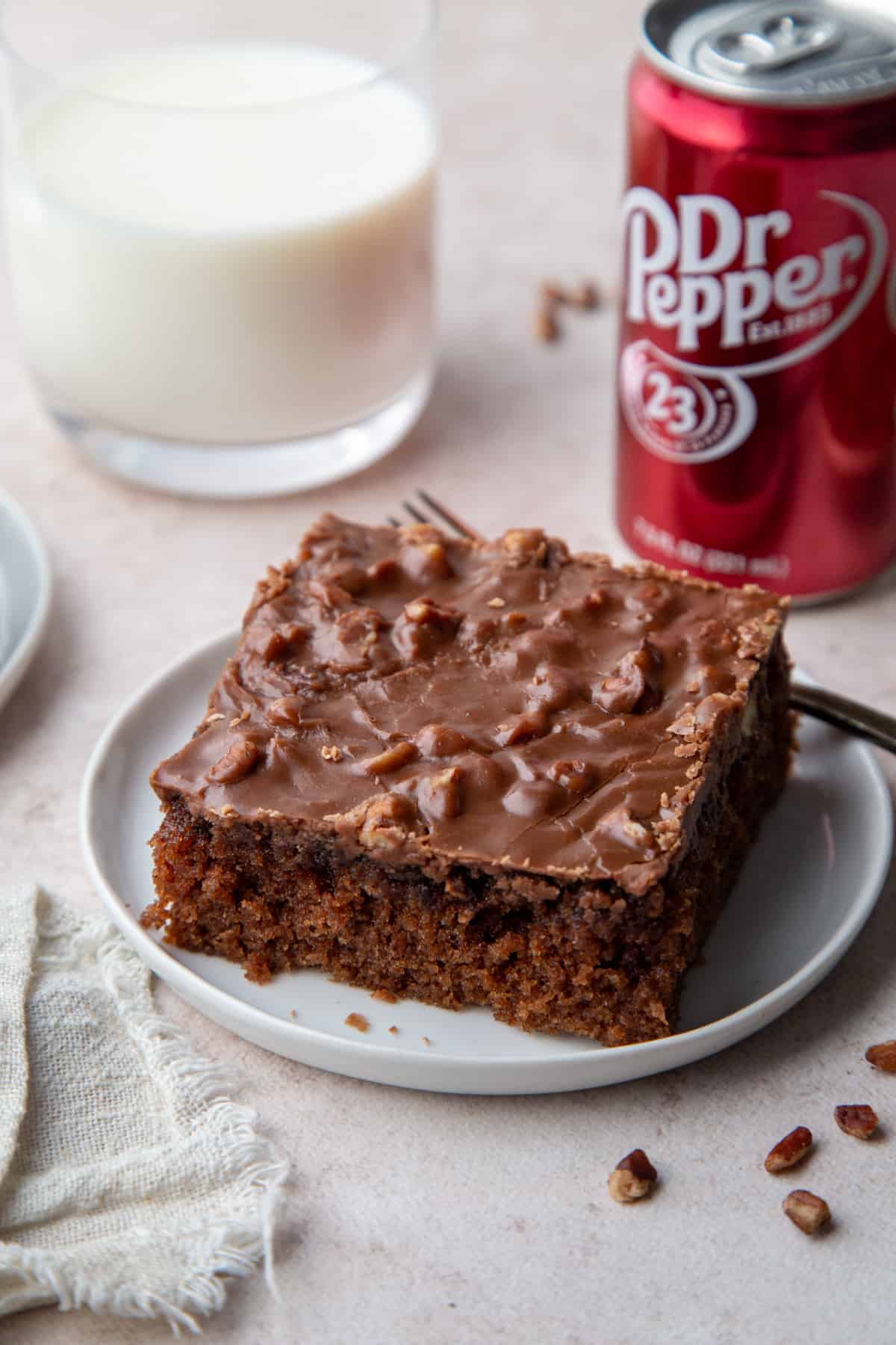 slice of dr pepper cake on a white plate.