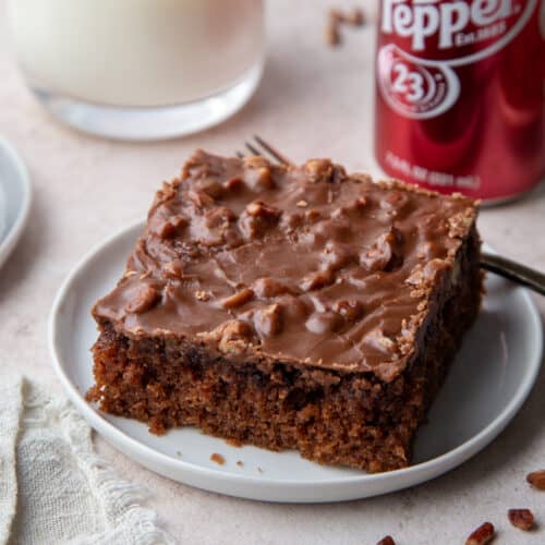 slice of dr pepper cake on a white plate.