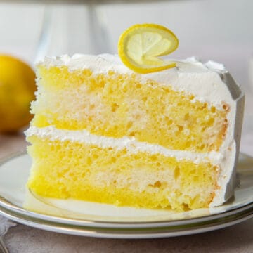 slice of lemon poke cake with cool whip frosting.