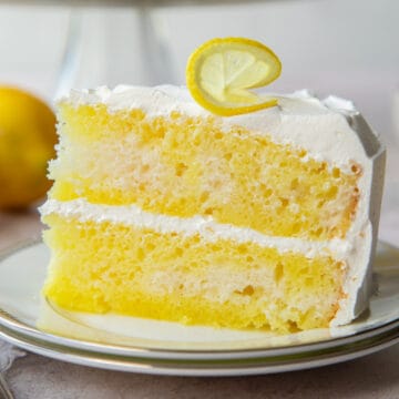 slice of lemon poke cake with cool whip frosting.