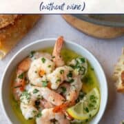 shrimp scampi in a low white bowl.