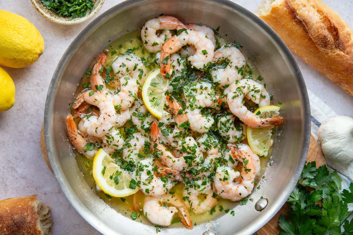 metal skillet filled with shrimp scampi.