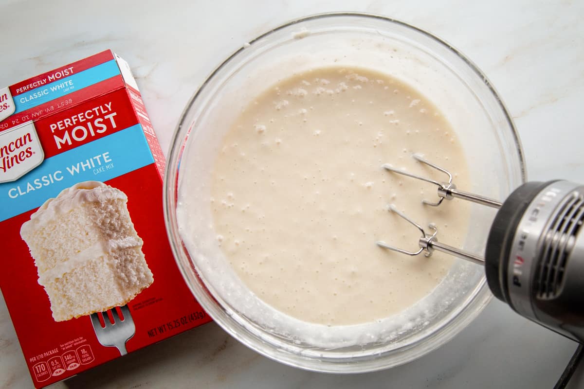 white cake batter in a glass bowl.