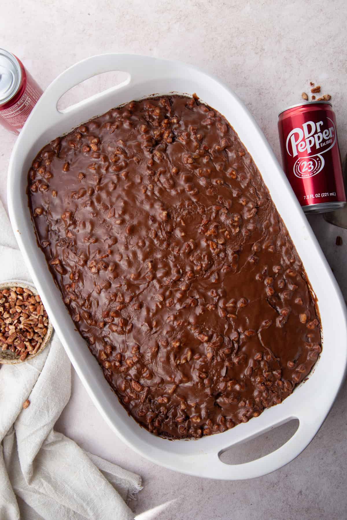 whole dr. pepper cake topped with pecan chocolate frosting.