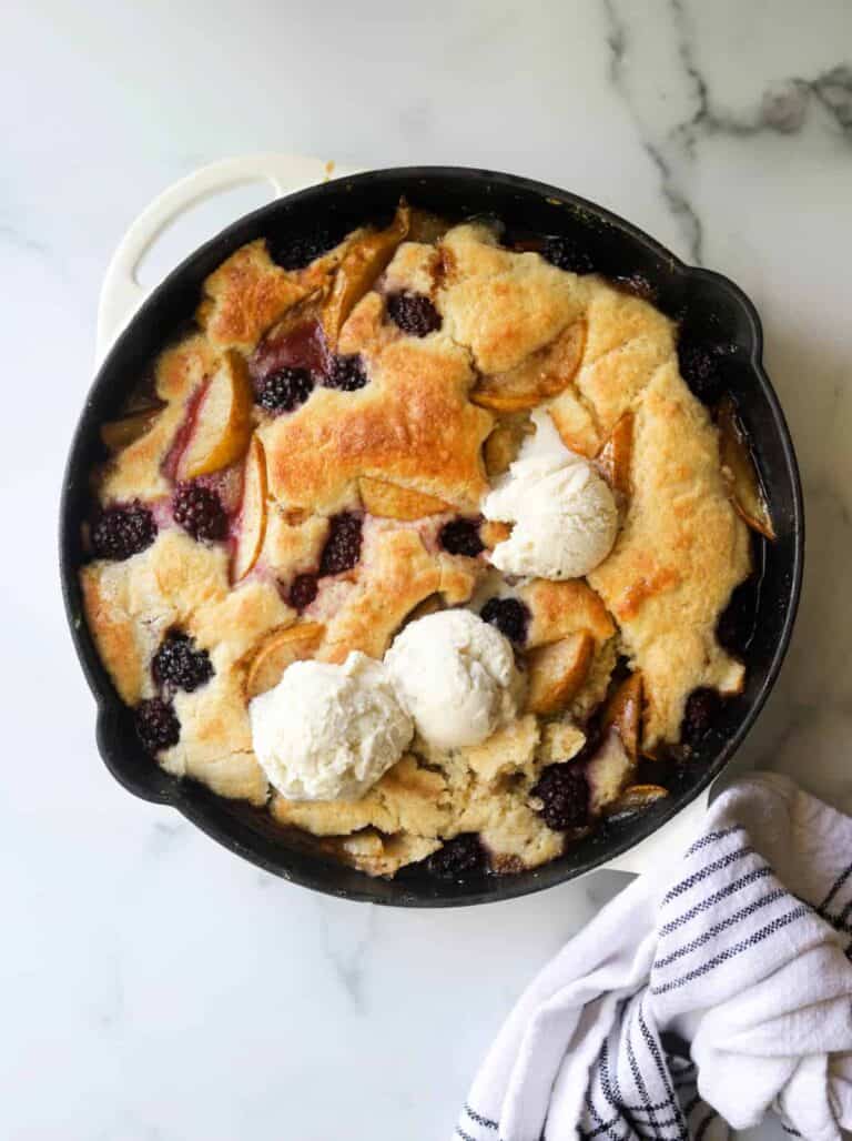 Top view of a Blackberry Pear Cobbler in a black cast iron skillet.